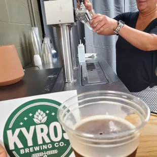 a woman filling a pint of beer