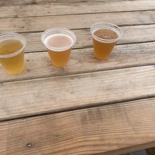 three glasses of beer on a wooden table