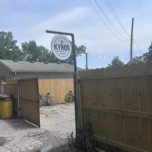 a bicycle parked in front of a wooden fence