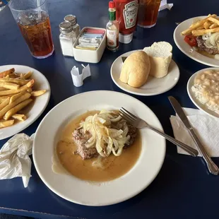 Hamburger Steak, gravy fries and bread.