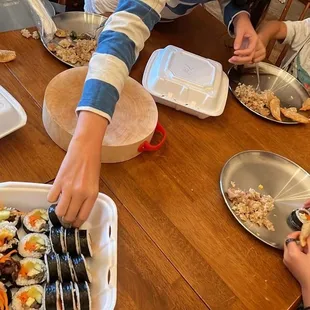 a group of children eating sushi