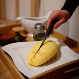 a person cutting a cake with a knife