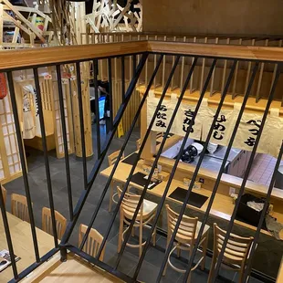 View from upstairs looking down on the barstool seating for kitchen viewing area