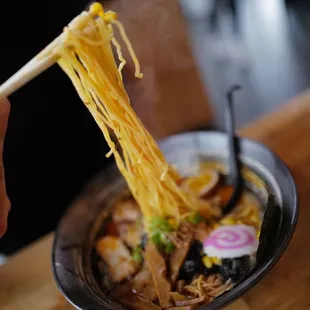 a bowl of ramen with chopsticks