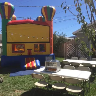 Bouncehouse and tables and chairs. Ready for all your party needs