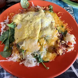Plate full of spuds, with three items: corned beef, spinach and egg plus cheese. Yummy.