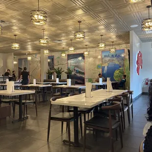 a restaurant with tables and chairs