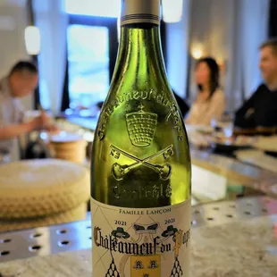 a bottle of wine sitting on a counter