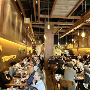a large group of people eating in a restaurant
