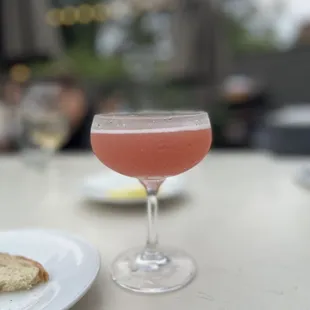 a glass of wine and a piece of bread