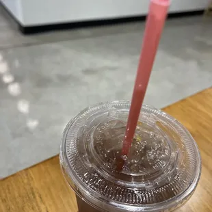 a plastic cup with a pink straw