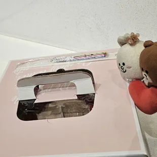 Peeking in... See the white plastic knife and colorful candles taped to the box?