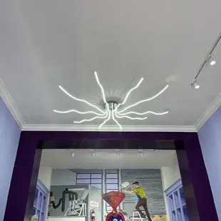Mural of chocolatier on the back wall (by the chocolatier himself!) and a pretty light fixture