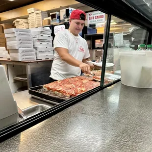 a man preparing pizza