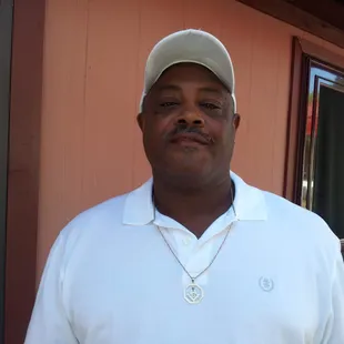 a man in a white shirt and hat