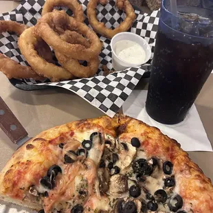 a slice of pizza and onion rings