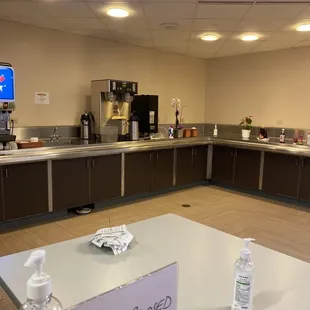 a kitchen with a table with a sign on it