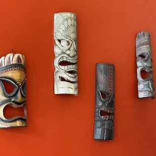 a variety of tiki masks