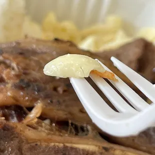 a fork with a piece of meat on it