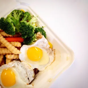 Loco Moco: Beef Patty with Sunny Side Up Eggs with Fries and Vegetables