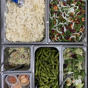 Selection of sides: Mac Salad, kimchi, edamame, Asian slaw, Red bean salad, garden greens