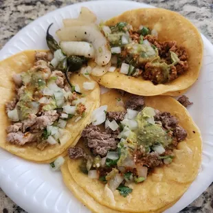 three tacos on a paper plate