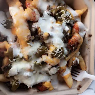 Steak &amp; Shrimp cheese fries with sour cream &amp; Jalapeños!