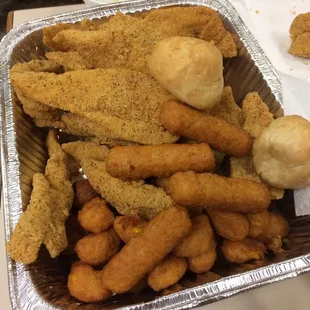 a tray of fried fish and hot wings