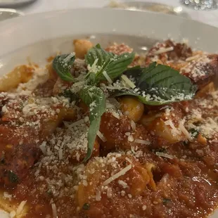a plate of pasta with meat and cheese