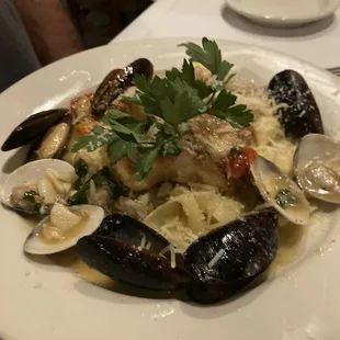 Mussels, clams and assorted seafood in a white wine sauce with fresh papardella pasta