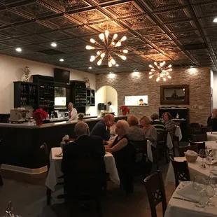 a group of people sitting at tables in a restaurant