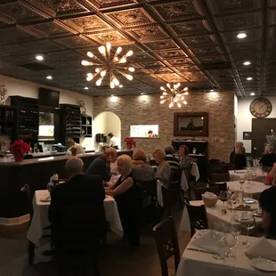 a group of people sitting at tables in a restaurant