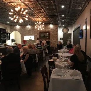 a large group of people sitting at tables in a restaurant