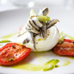 a plate of food with tomatoes and anchovies