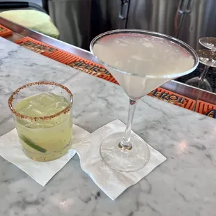 two cocktails on a bar
