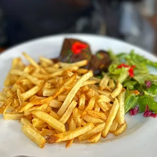 a plate of french fries and a salad