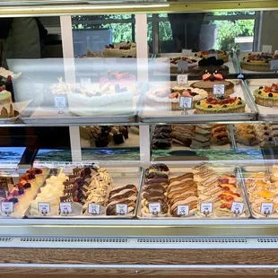 a variety of pastries in a display case