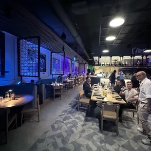 people sitting at tables in a restaurant