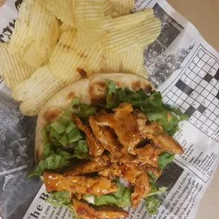 Sweet and spicy grilled chicken pita with chips.