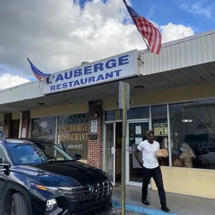 a man standing in front of the restaurant