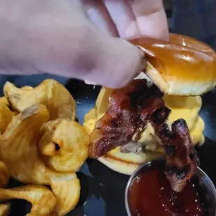 a burger with bacon and onion rings
