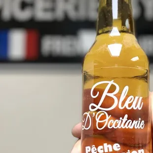 a person holding a bottle of beer