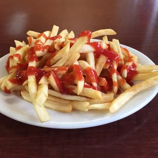 a plate of fries with ketchup and ketchup
