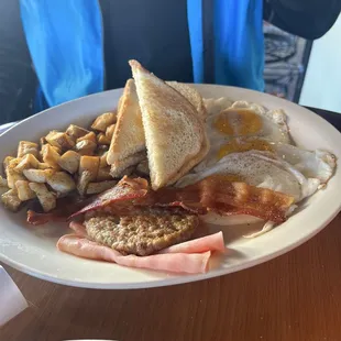 The grande breakfast with 3 eggs, potatoes, 3 meats with toast!