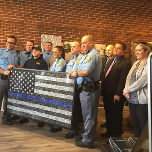Sedgwick County Sheriffs with Blue Line flag framed by L'image and signed by the Wichita Community in memory of Deputy Robert Kunze.