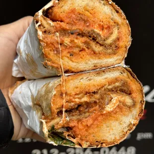 a hand holding a sandwich