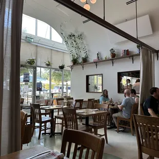 people sitting at tables in a restaurant