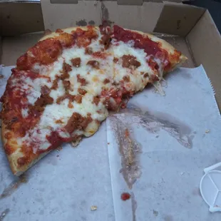 a half eaten pizza in a box