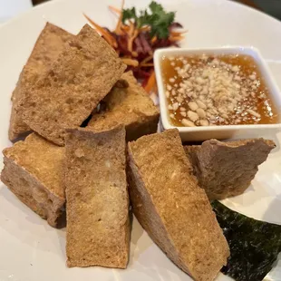 a plate of crisped bread and dipping sauce