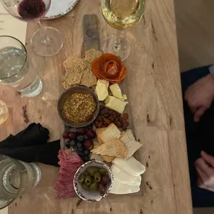 a wooden table with wine glasses and plates of food